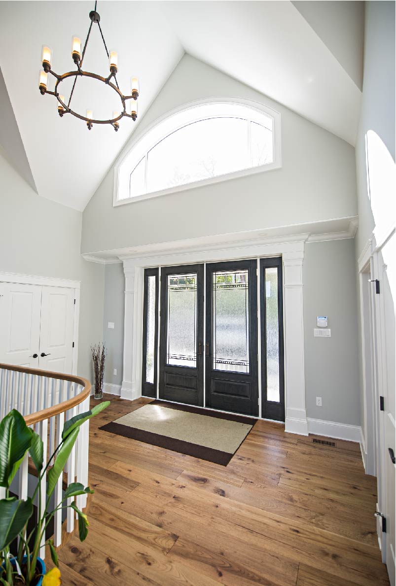 interior view of elegant entry way with double doors in Black and large overhead fixed window